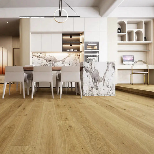 Modern kitchen with light oak hardwood flooring, white cabinets, and marble accents